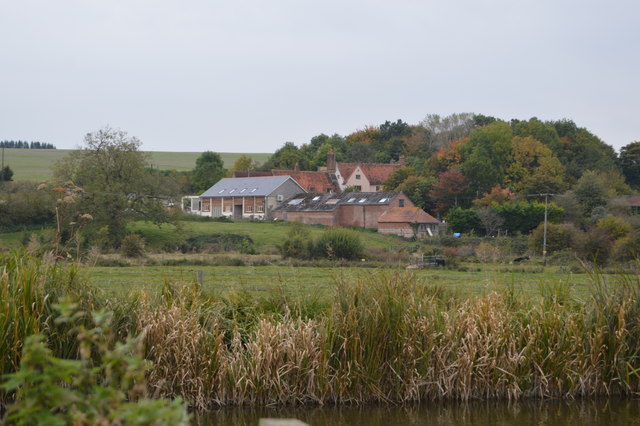 Hopgrass Farm barn at dusk with festoon lights and rustic beams